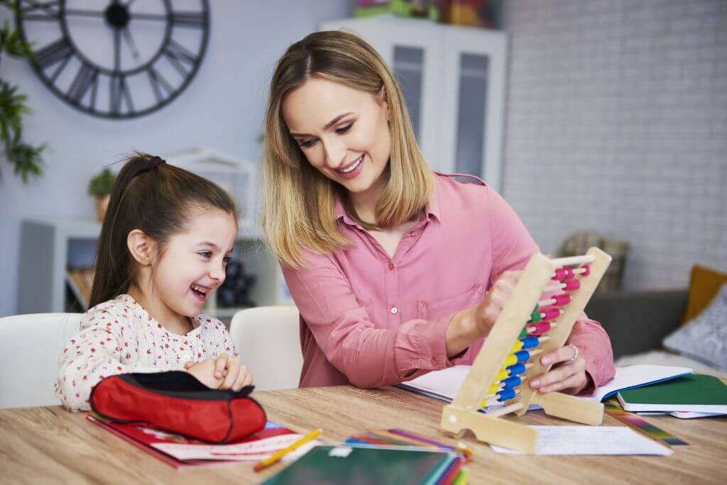 Young mother and child studying at home